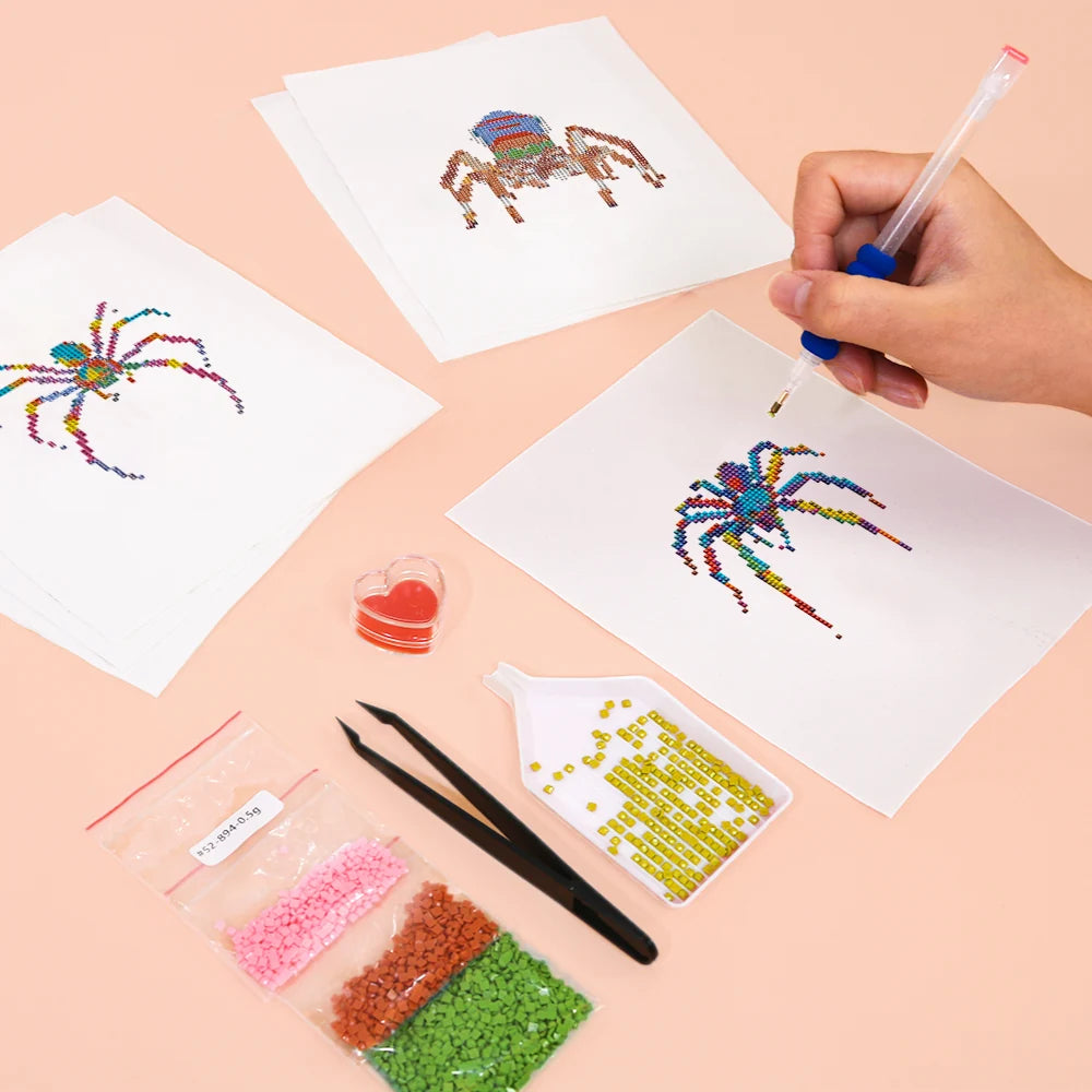 Working on several Colourful Spiders mini diamond painting designs with drills and applicator
