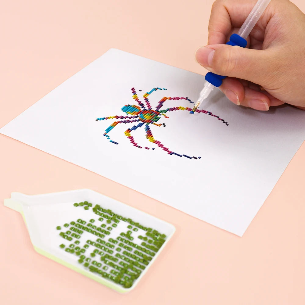 Close-up of drills being placed on a Colourful Spiders mini diamond painting design