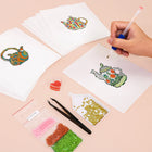 Working on several Colourful Teapots mini diamond painting designs with drills and applicator
