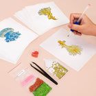 Working on several Colourful Tropical Fish mini diamond painting designs with drills and applicator