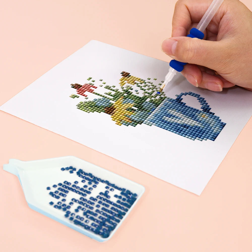 Close-up of drills being placed on a Cottage Garden Teacups mini diamond painting design