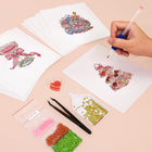 Working on several Festive Ornaments & Gifts mini diamond painting designs with drills and applicator