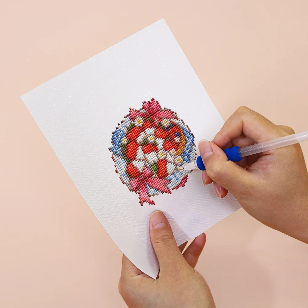 Applying drills to a Festive Ornaments & Gifts mini diamond painting design