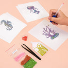 Working on several Ocean Coral & Shells mini diamond painting designs with drills and applicator