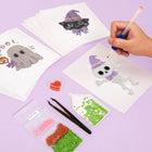 Working on several Pastel Halloween Cuties mini diamond painting designs with drills and applicator