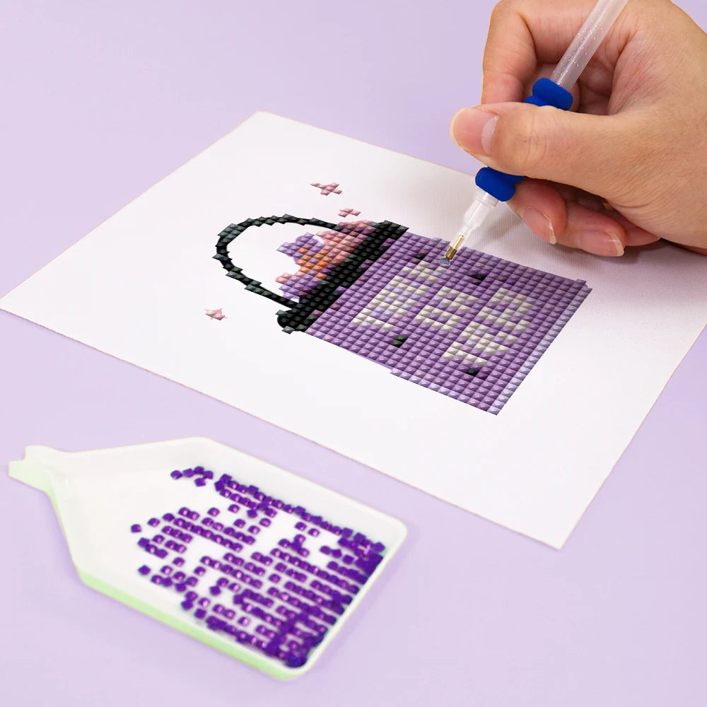 Close-up of drills being placed on a Pastel Halloween Cuties mini diamond painting design