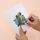 Applying drills to a Tropical Birds & Blooms mini diamond painting design