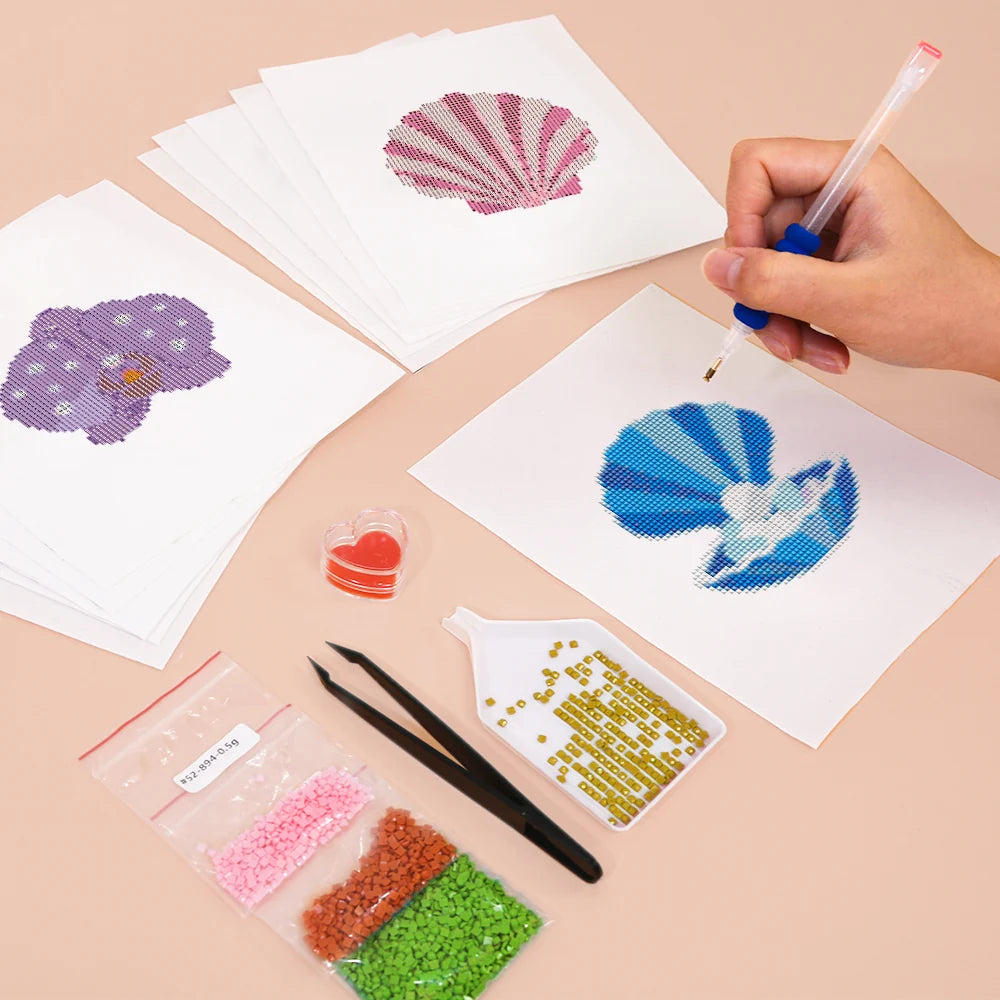 Working on several Tropical Blooms & Shells mini diamond painting designs with drills and applicator