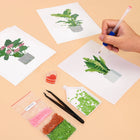 Working on several Tropical Houseplants mini diamond painting designs with drills and applicator