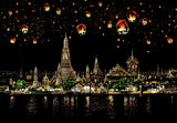 Stylized nighttime cityscape featuring ornate temple architecture beside a river in nighttime waterfront