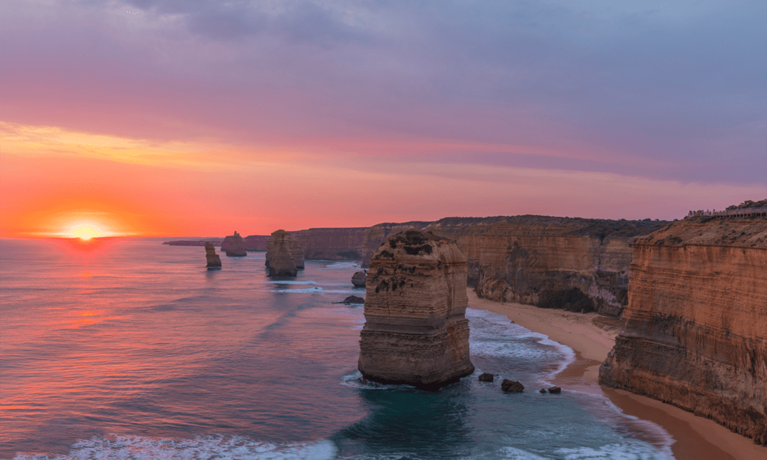 Coastal cliffs and freestanding sea stacks at sunset